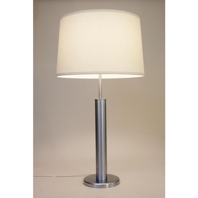 A brilliant and stunning monumental Mid Century Modern brush Stainless Steel table lamp designed and manufactured by...
