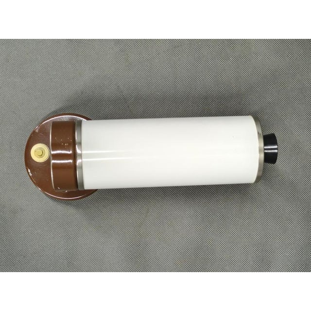 Minimalist adjustable wall light produced by napako in czechoslovakia during the 1960s. This elegant mid-century modern...