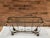 Vintage hand forged wrought iron garden solarium console table. 54” wide x 16” deep x 31” tall Glass top measures 48” x 12”