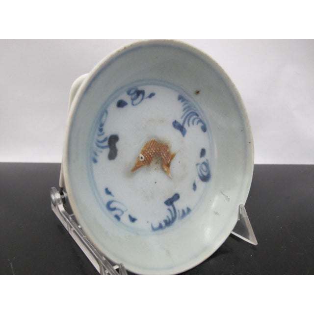 Chinese Hongzhi -Zhengde Ming Dynasty plate. Small saucer dish is decorated with a raised moulded goldfish colored in...