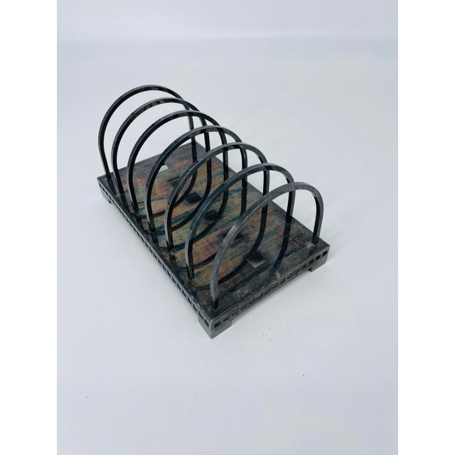 Solid vintage metallic letter holder. Base is set upon four feet with perforated holes along sides.