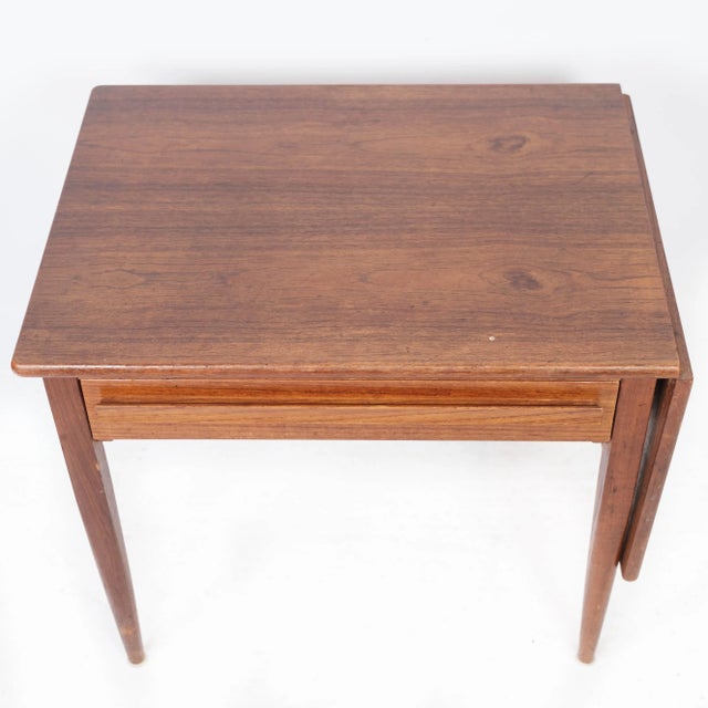 Side table with extensions in teak of Danish design manufactured by Silkeborg Furniture in the 1960s. The table is in...