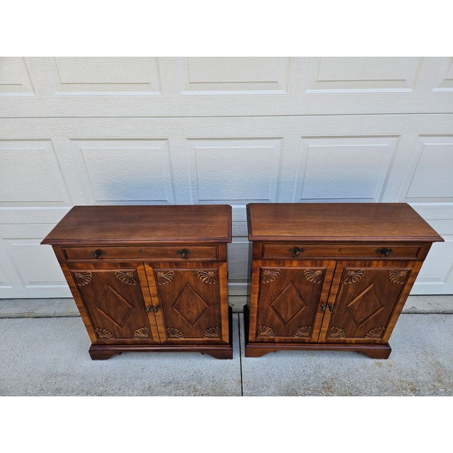 This pair of CTH Sherrill Occasional mahogany cabinet features elegant, traditional designs with details like a faux...