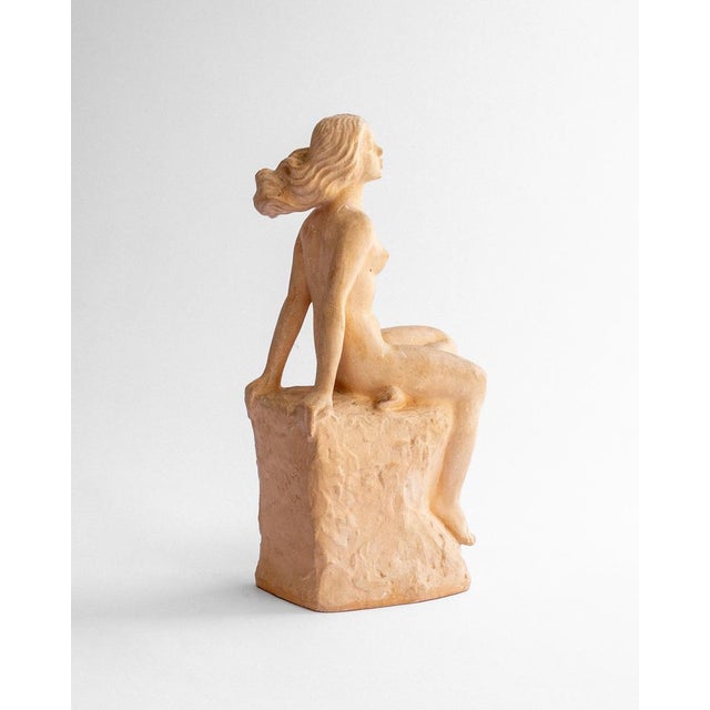 A beautifully expressive sculpture in painted plaster, depicting a seated female figure, signed and dated 1944 by sculptor...