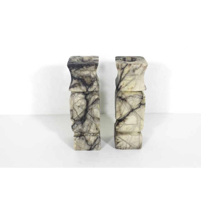 Pair of antique carved Italian alabaster marble candleholders with black and grey veining. One has a crack in a vein...