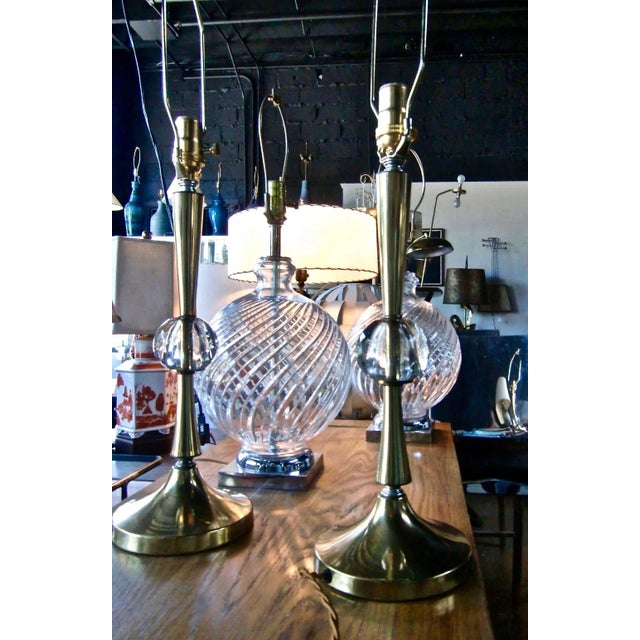 Pair of American Mid Century finely crafted reflective Brass and Crystal Table Lamps. Small footprint. Featuring a...