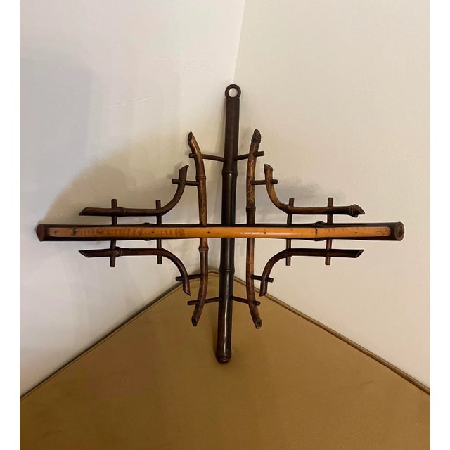 This antique Victorian style burnt bamboo corner shelf has a unique feature in that the Chinoiserie style painted motif of...