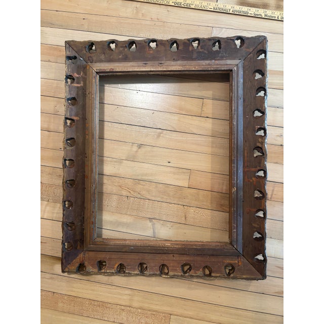 Muted gold finish ornately carved wooden frame. 16x20" opening, 24.5x28.5" outer edges