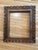 Muted gold finish ornately carved wooden frame. 16x20" opening, 24.5x28.5" outer edges