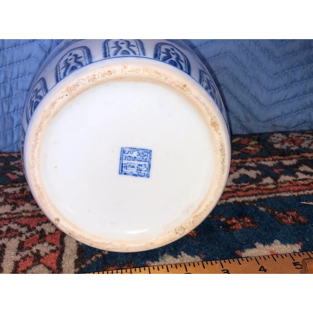 A beautifully aged blue and white porcelain ginger jar and lid with a Phoenix motif. There is an old 4 character Chinese...