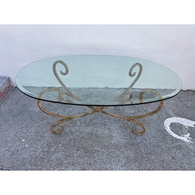 Vintage Hollywood Regency Style Coffee Table Featuring a Gold-Finished Wrought Iron Base With Scrollwork and an Oval Beveled Glass Top For Sale - Image 4 of 7
