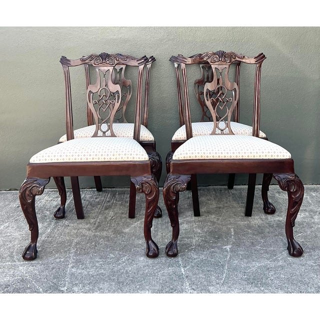 This exquisite set of four dining chairs is a masterclass in Chippendale-inspired design, showcasing the timeless elegance...