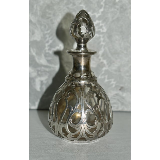 Antique (1900's) Perfume Bottle with Stopper and Silver Overlay. This Bottle has an Art Nouveau Style. It is Marked on the...