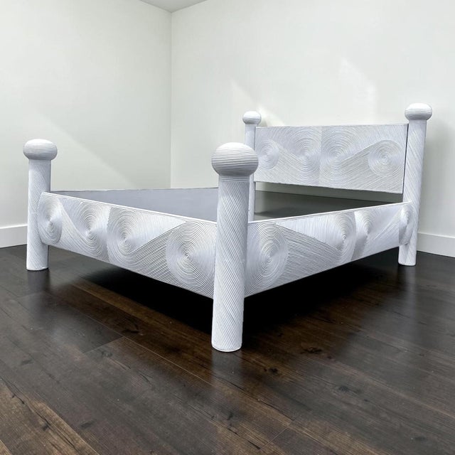 Queen size pencil reed ratan bed, features a full veneer of ratan in an artistic pattern, reminiscent of designs by...