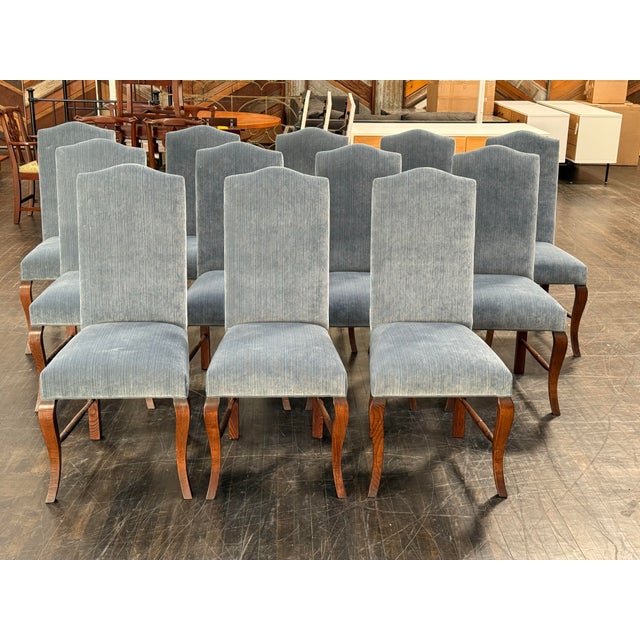 Design Plus Gallery presents a Set of Twelve Dining Chairs. Each chair has a tall, upholstered back and seat in a blue...