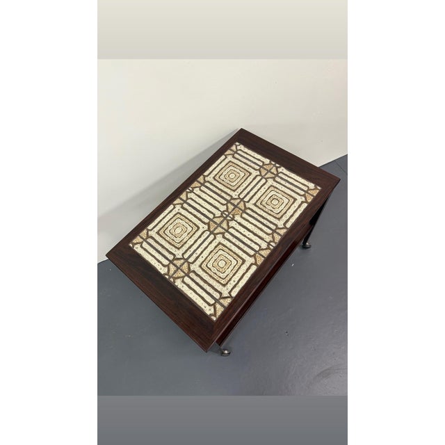 Beautiful rosewood and fantastic geometric tile pattern on the top surface. On casters for easy mobility. Excellent...