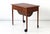 This teak sewing box table on castors was produced in Denmark in the 1960s.