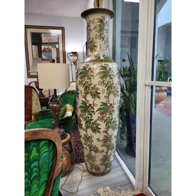 A Famille Verte-style porcelain floor vase, characterized by a predominant use of green enamels and iron red, yellow, and...