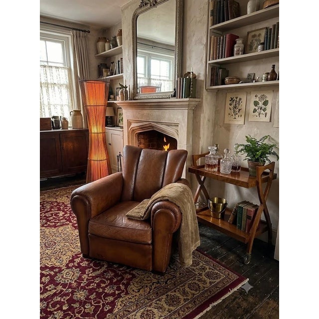 Authentic 1950s leather club chair. with its high, faceted back (Art Deco style) and generous armrests, it boasts a...