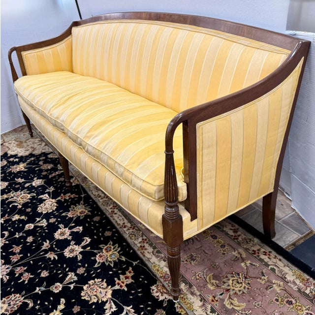 Elegant antique Federal style sofa, featuring a graceful exposed wood frame and classic fluted legs. The gently curved...