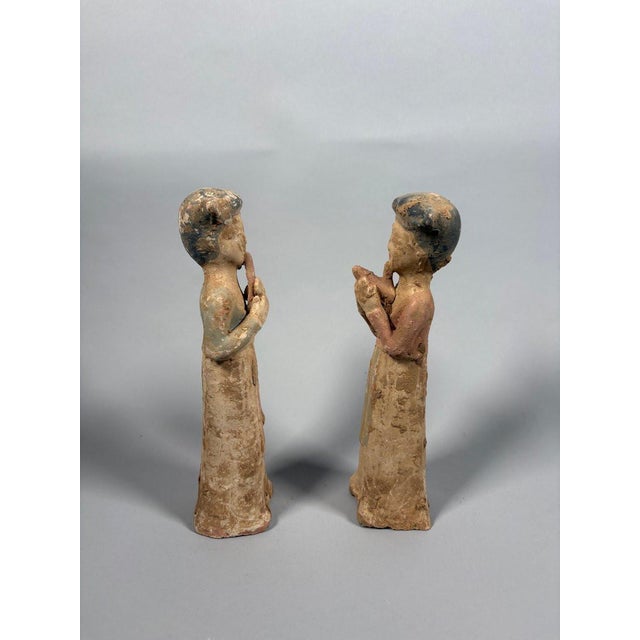 Pair of Mingqi Sculptures of Female Musicians, China, Tang Dynasty (618-907). Terracotta sculptures painted with...