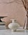 The Handcrafted "Calpide Granito" Decorative Vase by Canoa Lab is a sculptural stoneware vessel inspired by the historic...