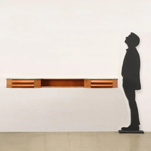 Hanging console with wall anchoring, visible drawers and open compartment; maple veneered wood, glass resting on the top....