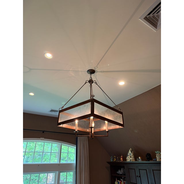 Hand forged, small batch crafted chandelier created using natural metals and an unusual type of translucent oyster shell....