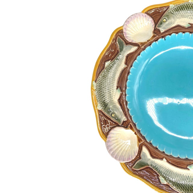 Minton Majolica seafood plate with fish and shells, English, dated 1873, the scalloped center glazed in turquoise,...