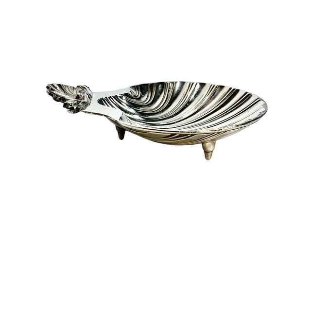 A charming vintage Sheffield inspired silver plate dish in an elegant scallop shell form, beautifully rendered with...