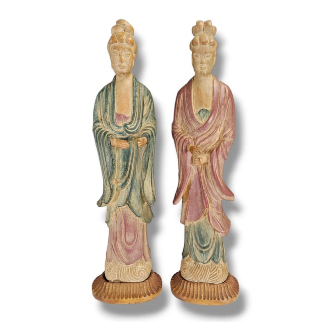 Pair of hand-carved wooden Guanyin figures rendered in classical robes with serene expressions and softly faded polychrome...