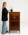 This piece presents as a side cabinet, distinguished by dark mahogany with inlay, drop-front, open showing shelf. The...