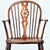 A handsome mid-19th century English wheelback Windsor chair built from solid elm, ash, and beech. Hand-crafted in the...