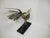 A handmade bird figure, made of toile in the primitive style. The bird is perched on a branch, it has leaf like wings and...