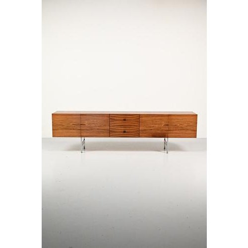 Very large rosewood side board with chrome base. The rosewood veneer really has a stunning wood grain which continues...