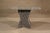 Simply designed polished marble dining table set on an X frame stone base.