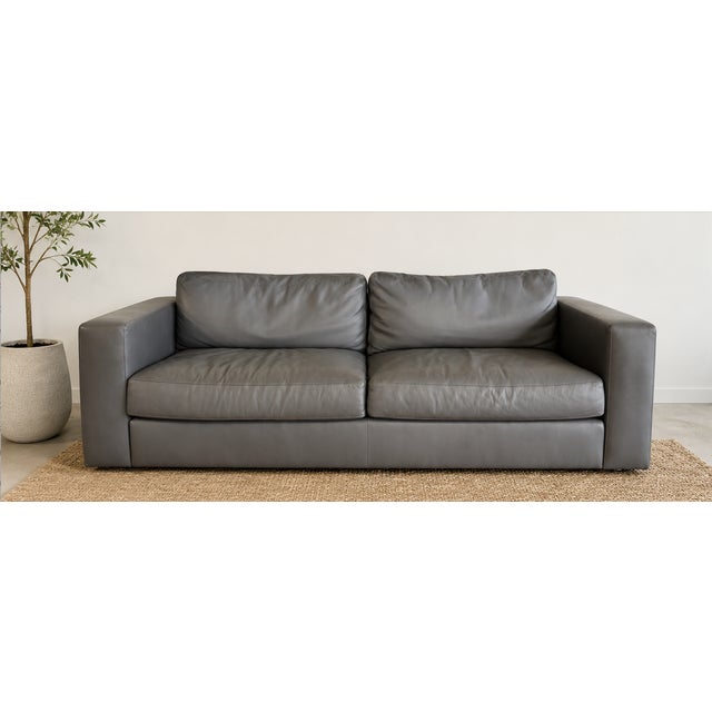 Authentic Design Within Reach Reid Sofa, 86", upholstered in gray leather. Designed by Jeffrey Bernett and Nicholas...