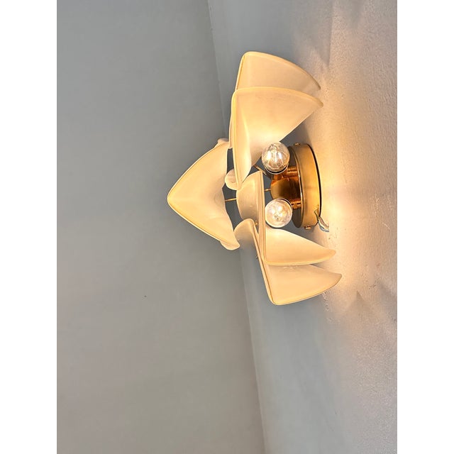 Scenographic and luxury Murano glass wall sconces. “Rondini” elements in Murano glass poured over a mold from a...