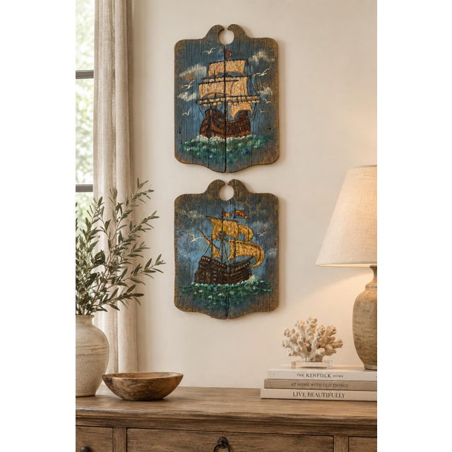 Sold as a pair, these wonderfully rustic vintage wall panels feature two sailing ships rendered against deep blue skies...