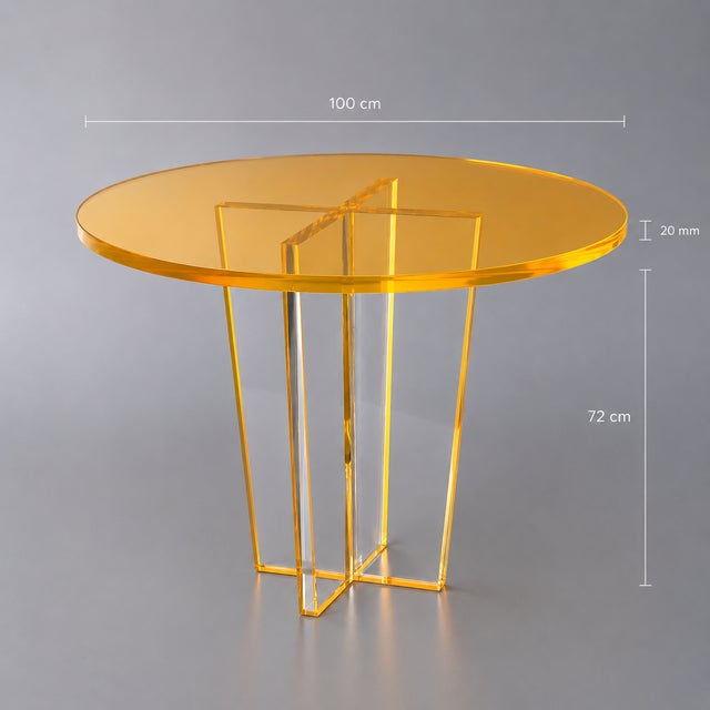 A striking sculptural dining table handcrafted from crystal-clear acrylic and finished with a vivid neon orange...