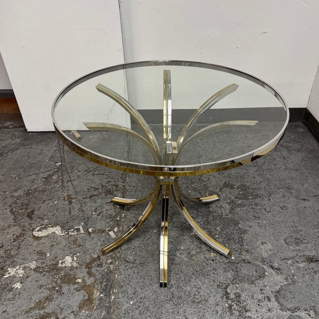 Design Plus Gallery presents a Vintage Italian Mid-Century Brass + Chrome Round Glass Dining Table. This distinctive table...