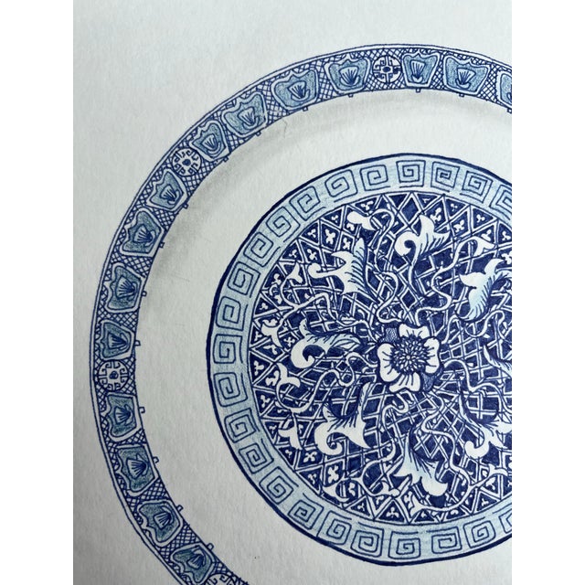 An original ink and colored pencil drawing of a tromp l’oeil Chinese export style blue and white porcelain plate. Paper is...