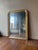 French giltwood mirror featuring a classic rectangular form with softly angled corners at the top, beaded inner molding,...