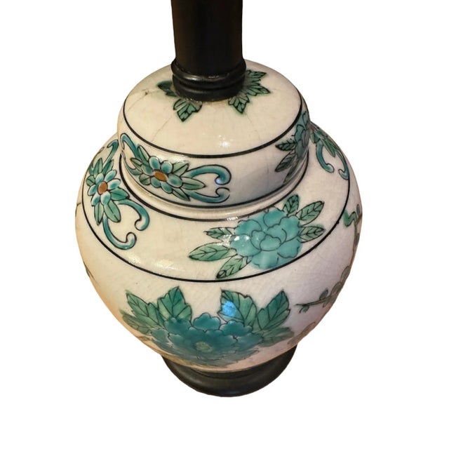 An antique Japanese Imari ginger jar porcelain lamp with lovely hand-painted peacocks, vibrant feathers, and flower...