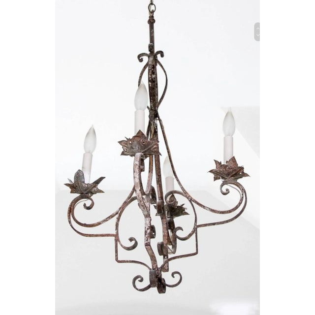We're excited to offer an antique Egyptian wrought iron four candle chandelier which has been electrified, converting it...