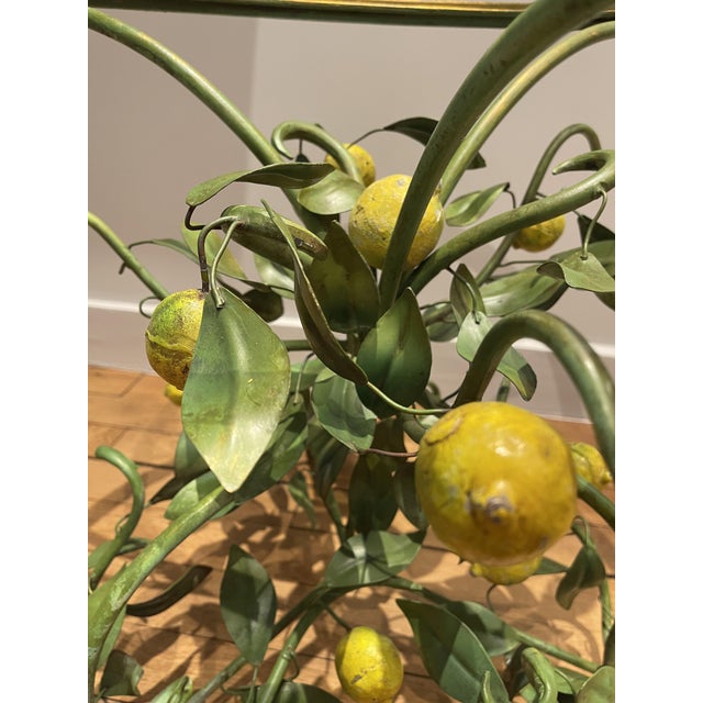 A painted sheet metal side table depicting a lemon tree, in the tradition of Italian, particularly Florentine, decorative...
