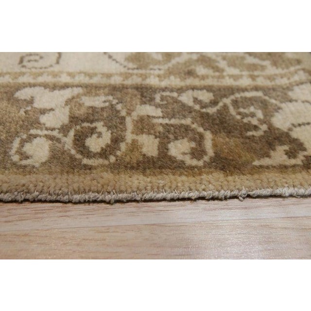 This hand knotted pile rug is crafted from wool and features a versatile color palette of ivory, beige, cream, and white....