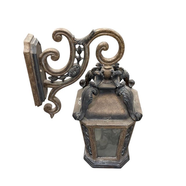 A striking vintage wall-mounted lantern of grand proportions, masterfully crafted in England. This piece features a...