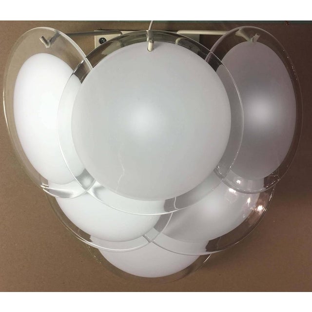 Each item made six discs of precious Murano glass are arranged on three levels. This piece is attributed to the mentioned...