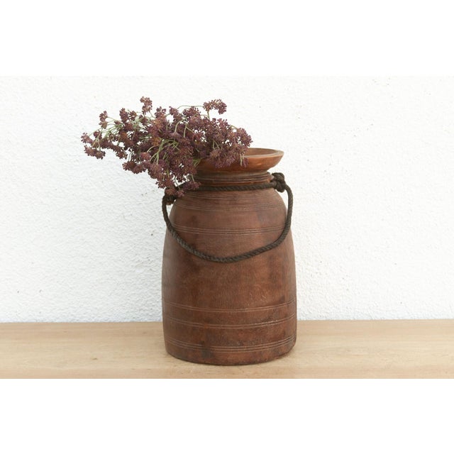 Originally used in village homes for storing milk, ghee, or grains, this antique wooden pot has survived generations of...